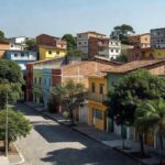 Bairro residencial brasileiro com casas e prédios, representando captação de imóveis para corretores